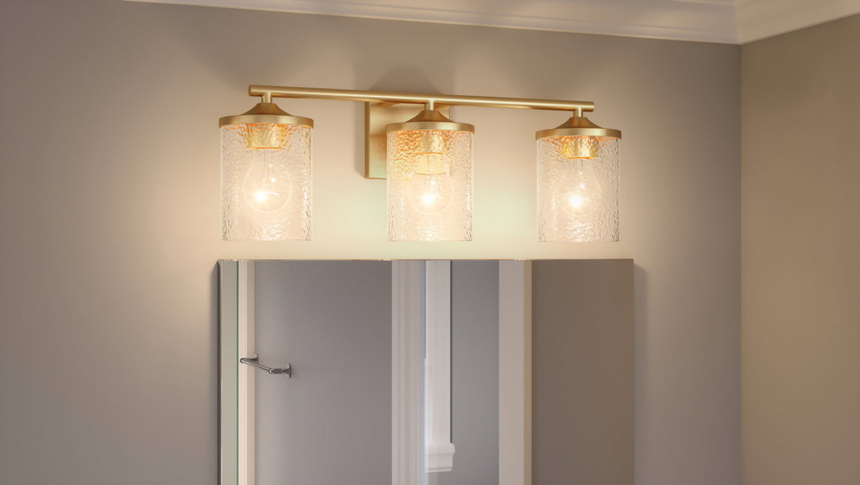 Three Light Bath from the Abner collection in Aged Brass finish